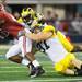 Michigan's sophomore defensive end Brennen Beyer and sophomore defensive back Raymon Taylor bring down Alabama freshman running back T. J. Yeldon during the second half of the Cowboy Classic at Cowboy Stadium in Arlington, Texas on Saturday. Melanie Maxwell I AnnArbor.com